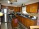 Traditional kitchen with wood cabinets, stainless steel appliances, island, and ample counter space at 55 Sw Fig Tree Ln, Dunnellon, FL 34431