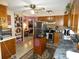 Cozy kitchen with breakfast bar, adjacent to Gathering room at 55 Sw Fig Tree Ln, Dunnellon, FL 34431