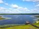 Scenic aerial view of a serene lake with a wooden pier at 55 Sw Fig Tree Ln, Dunnellon, FL 34431