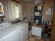Functional laundry room with a washing machine, dryer, and storage space at 55 Sw Fig Tree Ln, Dunnellon, FL 34431
