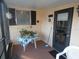 Enclosed patio with a door, window, and table with a plant at 55 Sw Fig Tree Ln, Dunnellon, FL 34431