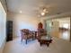 The living room opens to the dining room and features a ceiling fan and large windows at 6175 Sw 154Th Place Rd, Ocala, FL 34473