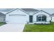 Charming single-story home featuring a two-car garage and well-manicured front lawn, perfect for modern living at 7161 Se 113Th Ln, Belleview, FL 34420