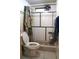 Simple bathroom with a tiled shower, toilet, and exhaust fan at 9205 Sw 152Nd Pl, Dunnellon, FL 34432
