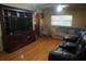 The living room is equipped with hardwood floors, ample seating, and a ceiling fan at 9205 Sw 152Nd Pl, Dunnellon, FL 34432