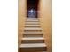 Stairwell with light-toned stairs and orange-toned walls at 9205 Sw 152Nd Pl, Dunnellon, FL 34432
