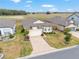 Aerial view of a home with a paver driveway, two-car garage, and manicured landscaping at 9581 Sw 63Rd Loop, Ocala, FL 34481