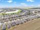A broad aerial shot showing a vast residential community nestled alongside a golf course and lakes at 9581 Sw 63Rd Loop, Ocala, FL 34481