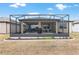 An inviting, screened-in back porch with comfortable seating offers an ideal outdoor living space at 9581 Sw 63Rd Loop, Ocala, FL 34481