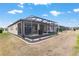 A backyard featuring a screened-in patio with a view of the property and the surrounding neighborhood at 9581 Sw 63Rd Loop, Ocala, FL 34481