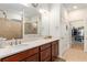 Bathroom features a double vanity with solid surface countertop and a large shower with brown tiling and a window at 9581 Sw 63Rd Loop, Ocala, FL 34481