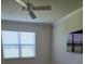 Bedroom featuring a modern ceiling fan and a window with privacy blinds at 9581 Sw 63Rd Loop, Ocala, FL 34481