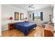 Well lit bedroom with wood floors, a window view, and classic decor and furniture at 9581 Sw 63Rd Loop, Ocala, FL 34481