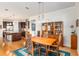 Open dining area with hardwood floors, china cabinet, and seamless connection to the kitchen at 9581 Sw 63Rd Loop, Ocala, FL 34481