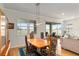 Dining room with wooden table and chairs, large windows, and sliding doors to the screened porch at 9581 Sw 63Rd Loop, Ocala, FL 34481