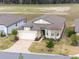 A well-manicured lawn and paver driveway lead to a charming home with an attached two-car garage at 9581 Sw 63Rd Loop, Ocala, FL 34481