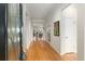 Bright foyer with gleaming wood floors, an arched doorway, and an ornate glass front door at 9581 Sw 63Rd Loop, Ocala, FL 34481