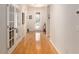 Hallway with hardwood floors leading to a glass door, and glass paneled doors, creating an open, airy feel at 9581 Sw 63Rd Loop, Ocala, FL 34481