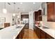 Gourmet kitchen with stainless steel appliances, a large island, and modern lighting fixtures at 9581 Sw 63Rd Loop, Ocala, FL 34481