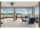 Relaxing lanai features a ceiling fan, outdoor seating and clear views at 9581 Sw 63Rd Loop, Ocala, FL 34481