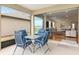 Open sliding glass doors lead to a charming lanai with outdoor furniture at 9581 Sw 63Rd Loop, Ocala, FL 34481