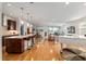Bright, open floorplan showcasing the kitchen, dining, and living room with hardwood floors and modern finishes at 9581 Sw 63Rd Loop, Ocala, FL 34481