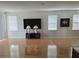 Bright living area with hardwood floors, large television, and modern decor at 9581 Sw 63Rd Loop, Ocala, FL 34481
