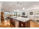Spacious open-concept kitchen, dining, and living area with hardwood floors and modern decor at 9581 Sw 63Rd Loop, Ocala, FL 34481