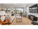 Bright living room with neutral color palette and sliding glass doors leading to outdoor space at 9581 Sw 63Rd Loop, Ocala, FL 34481