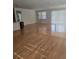 Spacious living room featuring gleaming hardwood floors and an abundance of natural light at 9581 Sw 63Rd Loop, Ocala, FL 34481