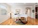Cozy living room featuring hardwood floors, natural light, and a white grand piano at 9581 Sw 63Rd Loop, Ocala, FL 34481