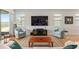 Stylish living room featuring modern entertainment center, comfortable seating, and scenic views at 9581 Sw 63Rd Loop, Ocala, FL 34481