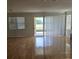 Bright and open living room with hardwood floors and sliding door access to outdoor space at 9581 Sw 63Rd Loop, Ocala, FL 34481