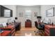 A home office featuring two cherry wood desks, an office chair, and natural light at 9581 Sw 63Rd Loop, Ocala, FL 34481