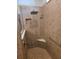 Close up on the large shower with tile surround, bench, hand-held showerhead, and grab bar at 9581 Sw 63Rd Loop, Ocala, FL 34481