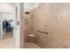Walk-in shower boasts tile surround, rainfall showerhead and grab bar at 9581 Sw 63Rd Loop, Ocala, FL 34481