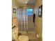 Bathroom featuring a toilet and walk-in shower with blue and white striped shower curtain at 9638 Sw 94Th Ct # A, Ocala, FL 34481