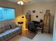 Bedroom featuring a sofa and a desk with a computer setup at 9638 Sw 94Th Ct # A, Ocala, FL 34481