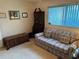 Bedroom featuring a plaid sofa and a dark wood dresser at 9638 Sw 94Th Ct # A, Ocala, FL 34481