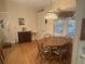 Cozy dining area with a wooden table and chairs, illuminated by a decorative hanging light at 9638 Sw 94Th Ct # A, Ocala, FL 34481