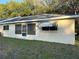 Home exterior featuring a screened porch and awning covered windows at 9638 Sw 94Th Ct # A, Ocala, FL 34481