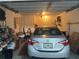 Spacious garage featuring ample storage space, lighting, and housing a silver Toyota Corolla for secure parking at 9638 Sw 94Th Ct # A, Ocala, FL 34481