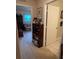 Hallway features carpeted floors, convenient bookcase, and easy access to living spaces at 9638 Sw 94Th Ct # A, Ocala, FL 34481