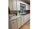 Well-lit kitchen with white cabinetry, laminate countertops, and a stainless steel sink at 9638 Sw 94Th Ct # A, Ocala, FL 34481
