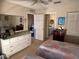Comfortable main bedroom featuring a ceiling fan, dresser, and ensuite bathroom at 9638 Sw 94Th Ct # A, Ocala, FL 34481
