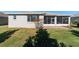 Backyard with a screened lanai and well maintained lawn at 9704 Sw 95Th Loop, Ocala, FL 34481