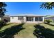 Home featuring a spacious backyard with a screened patio at 9704 Sw 95Th Loop, Ocala, FL 34481