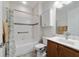 Well-maintained bathroom features a tub-shower combo, white tiles and neutral wall color at 9704 Sw 95Th Loop, Ocala, FL 34481