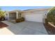 Home featuring a well-maintained driveway and attached garage at 9704 Sw 95Th Loop, Ocala, FL 34481