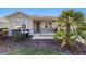 Inviting front porch with decorative shrubs and beautiful lawn at 9704 Sw 95Th Loop, Ocala, FL 34481
